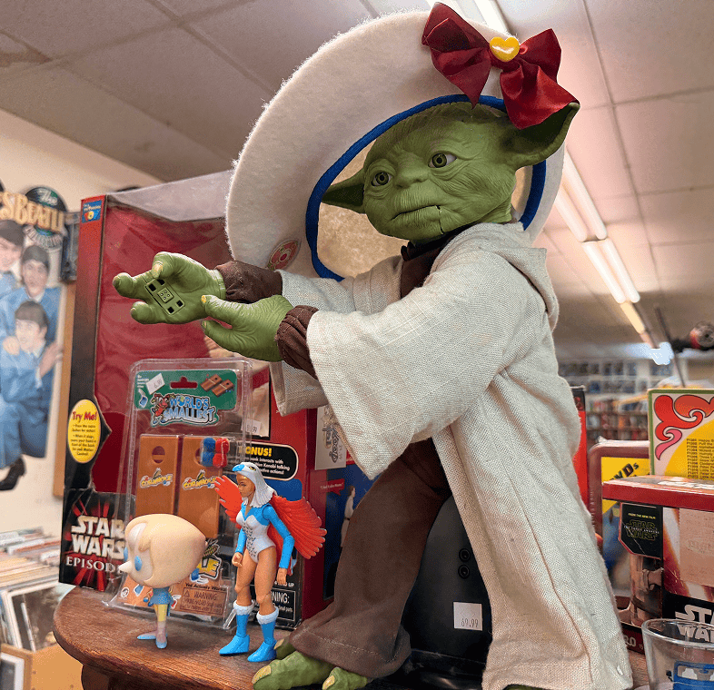 Yoda figure wearing a white hat, decorated.