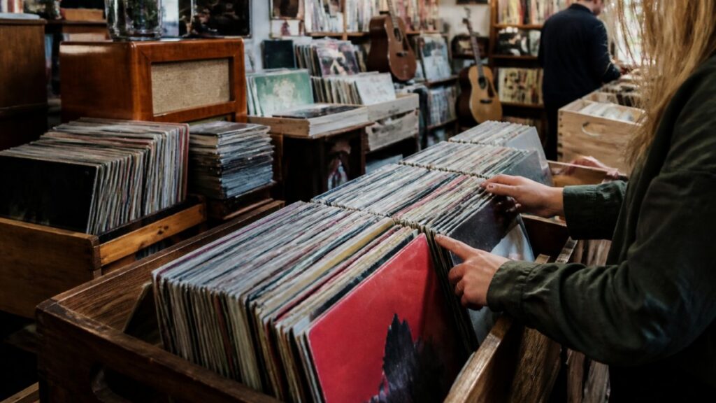 Person browsing through vintage vinyl records.